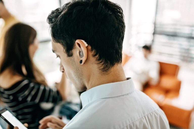 A younger man with hearing aids.
