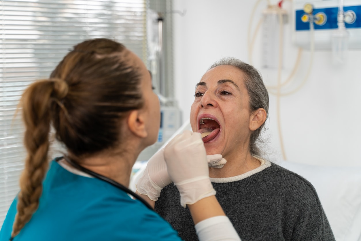 ENT provider checking a woman's tonsils