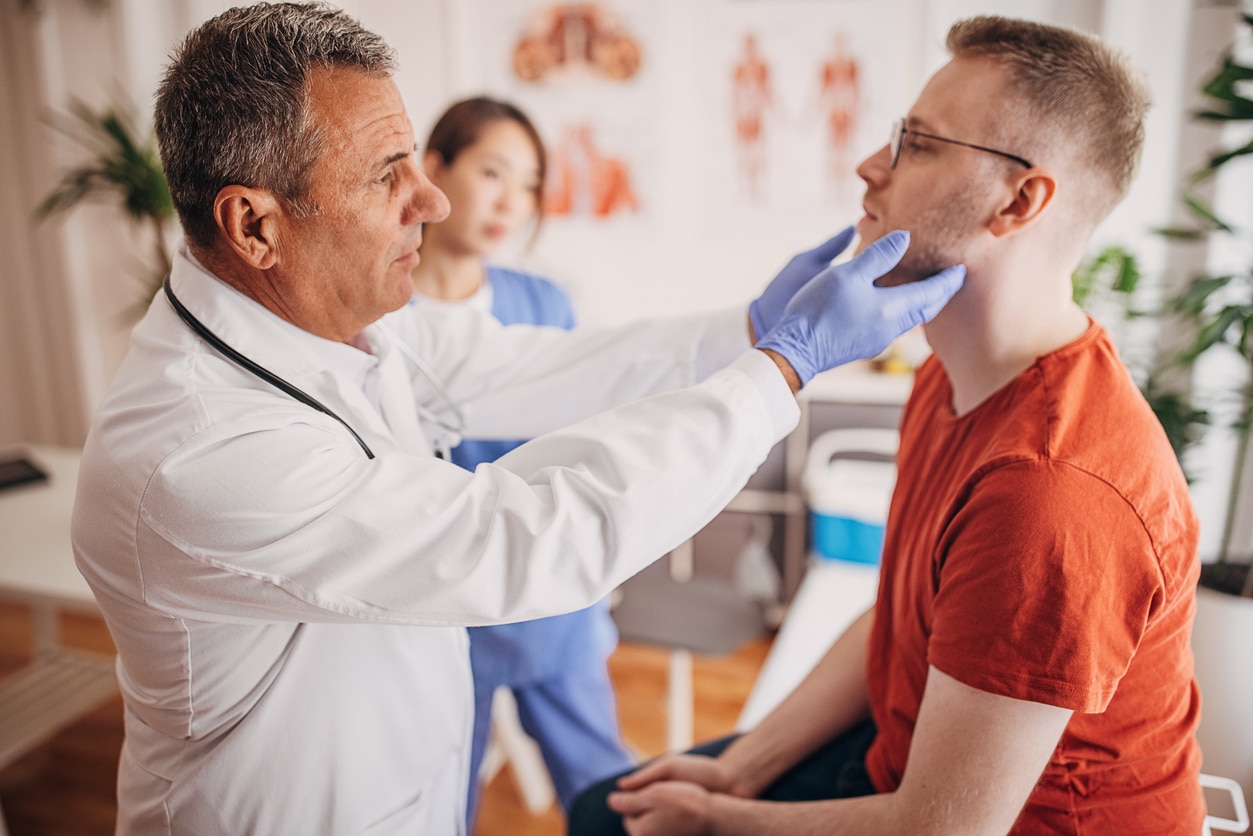 ENT examining a man's throat