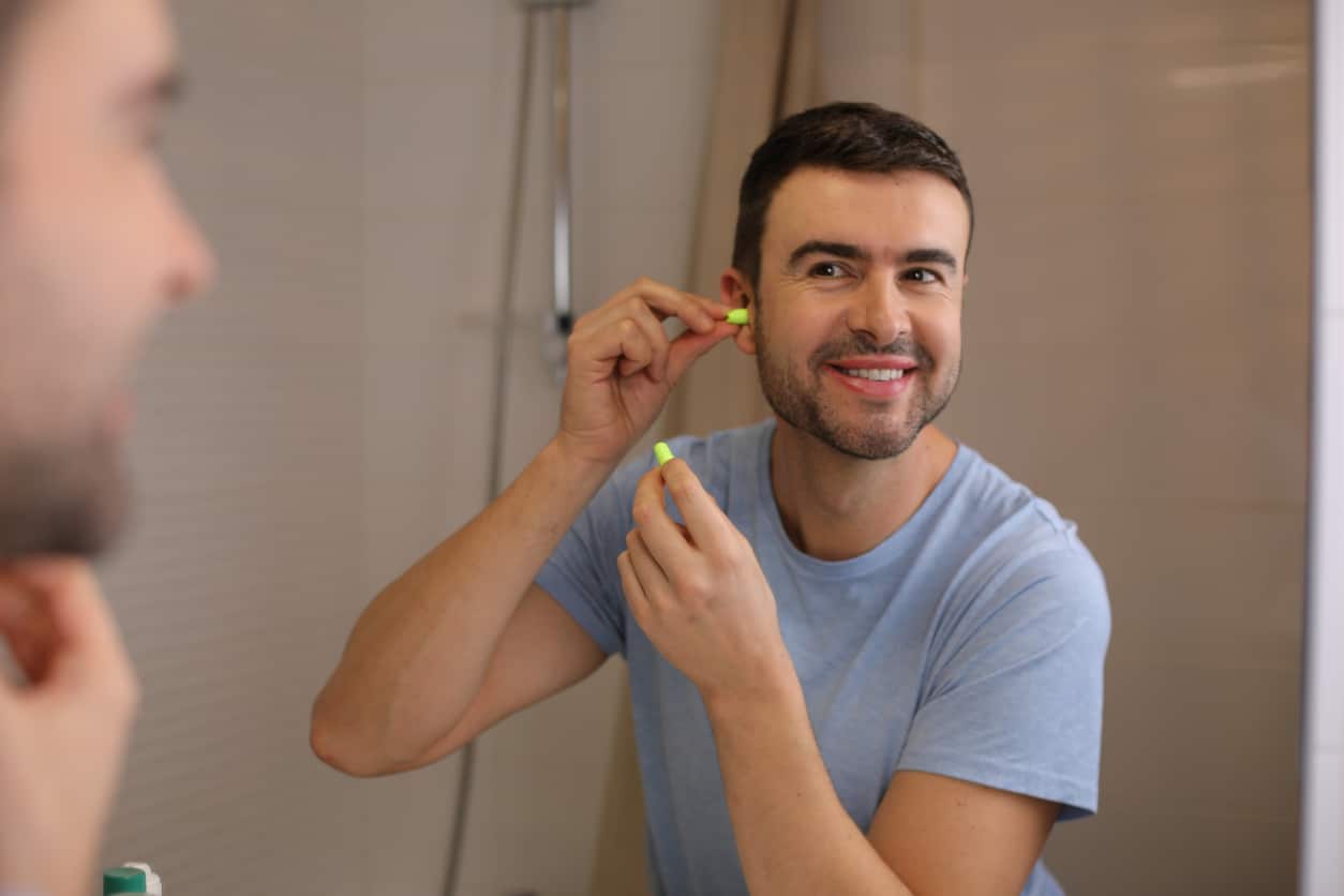 Man puts in hearing aid