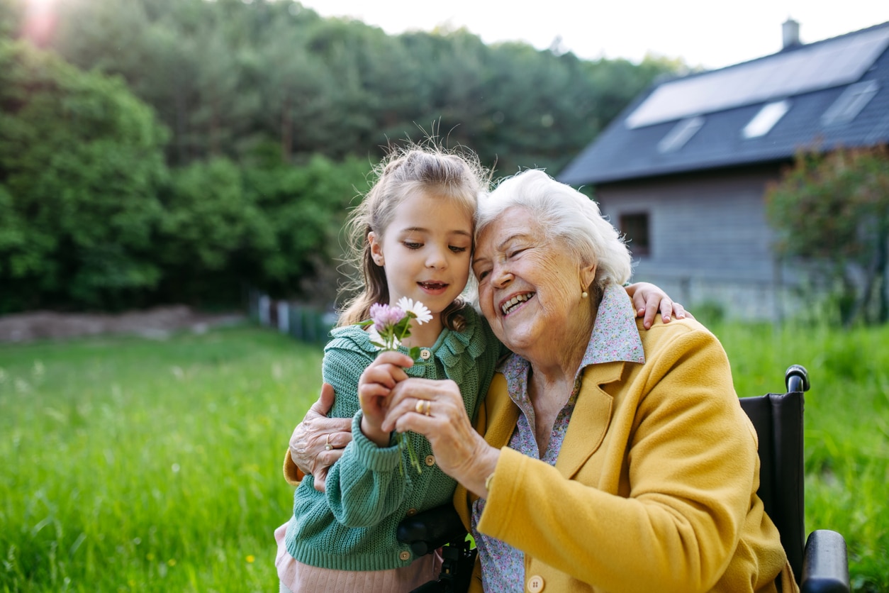 Grandmother and grandchild picking wildflowers